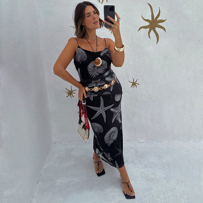 Black Seashell Mesh Cami Dress with white shell and starfish prints, styled with a gold belt in a mirror selfie.