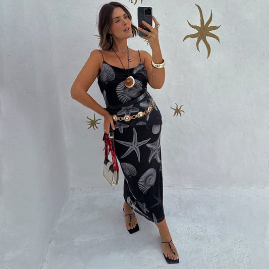 Black Seashell Mesh Cami Dress with white shell and starfish prints, styled with a gold belt in a mirror selfie.