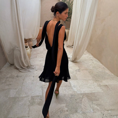 Black Sophie Mini Dress with a draped back and multi-wear scarf, designed in London with a fluid bias-cut.