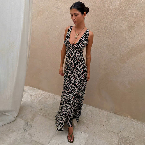 Black Spot Boni Dress with red and white spot print, featuring a deep V-neckline and bias-cut midi silhouette on a model.