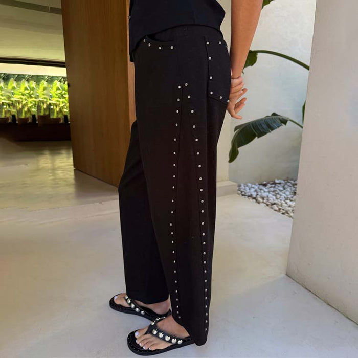 Black Studded Barrel Jeans featuring silver stud detailing along the side seam and back pocket in a lifestyle setting.
