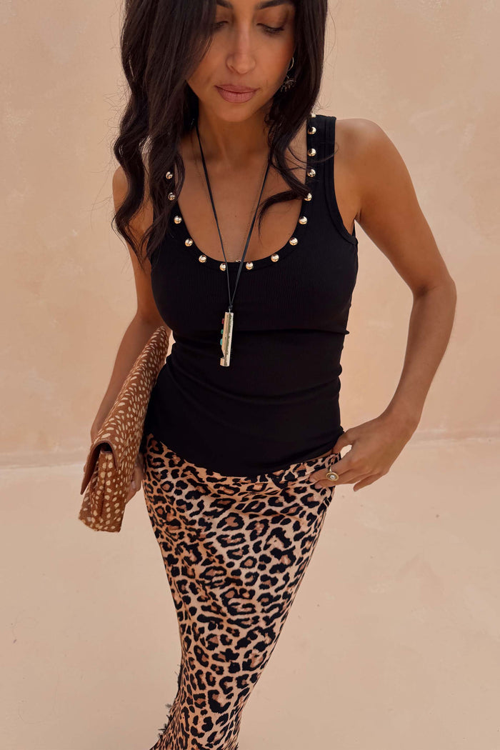 Black Studded Rib Vest with gold stud detailing, paired with a leopard print skirt for a London look.