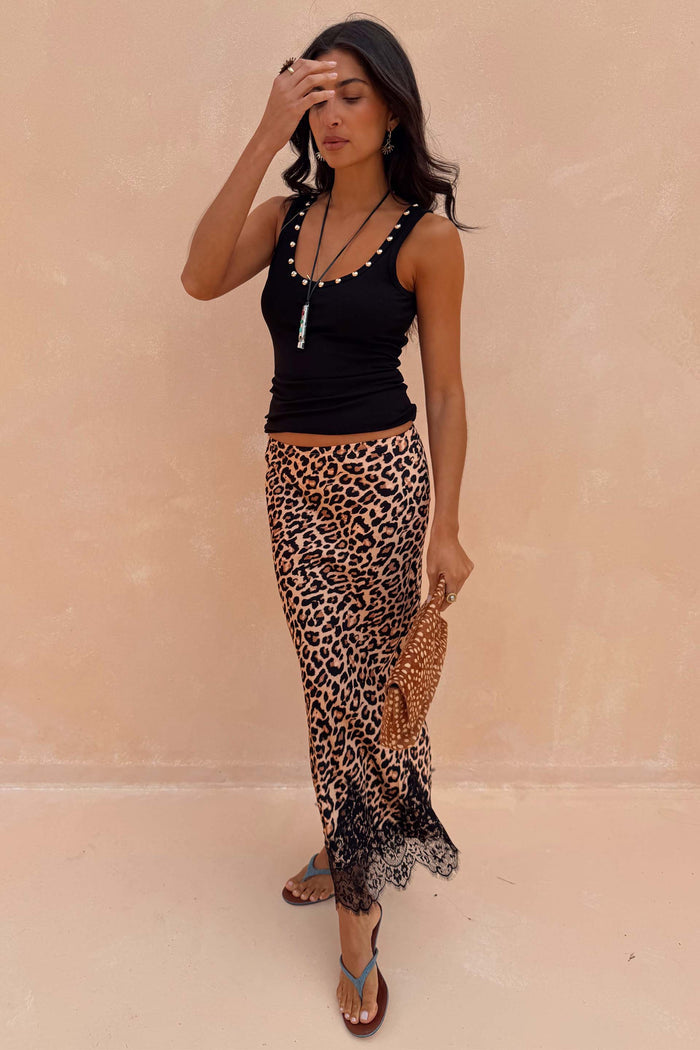 Black Studded Rib Vest featuring gold neckline detailing, styled with a leopard print lace-trimmed skirt.