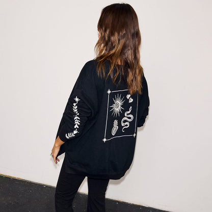 Black sweatshirt with ecru sun and snake embroidery on the back and sleeve, styled in a slightly oversized fit.