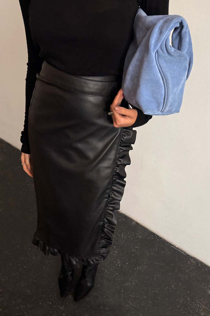 Black Vegan Leather Ruffle Jaspre Skirt featuring a wrap-tie waist and frill trim detailing.