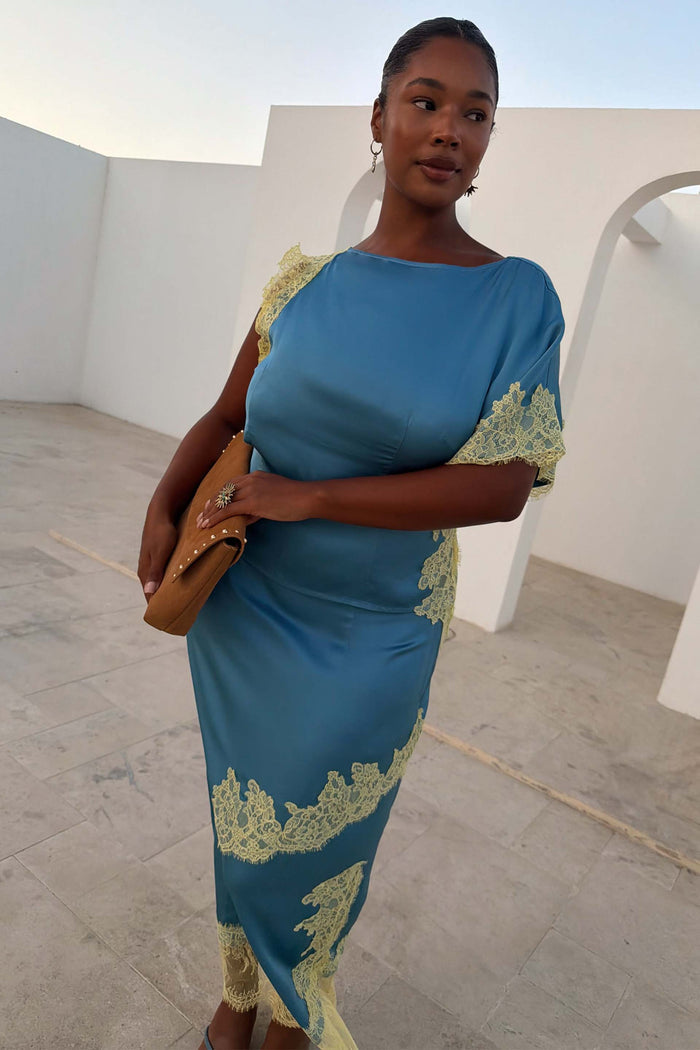 Blue and Lemon Kira Top with lemon lace trim and an asymmetric hem, shown on a model for curve fashion.