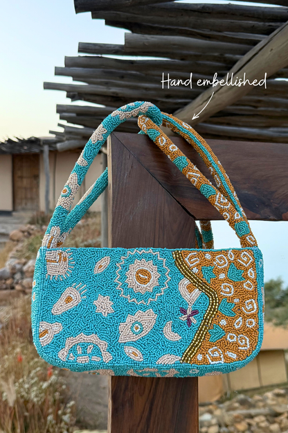 Blue and Yellow Morocco Beaded bag with hand-embellished glass beads, featuring iconic NFD motifs and gold detailing.