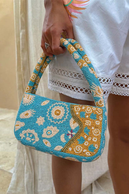 Blue and Yellow Morocco Beaded bag featuring hand-embellished glass beads and iconic gold NFD motifs.