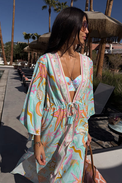 Blue Dreamer Maxi Kimono with colourful sun and heart motifs, featuring a flowy silhouette in a sunny poolside setting.