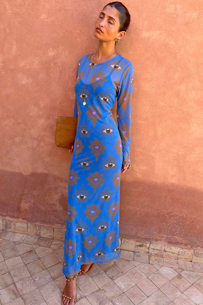 Blue Eye Mesh Dress with eye and heart motifs, long sleeves and a fitted maxi silhouette, styled on a model.