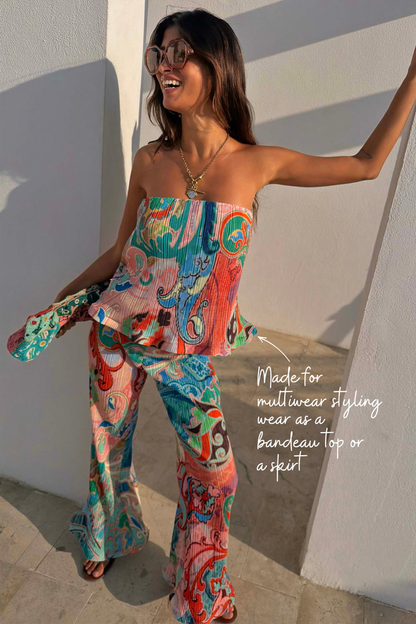 Blue Mari Plisse Bandeau Top in a multi-coloured paisley print, styled as a co-ord for multi-wear vacation looks.
