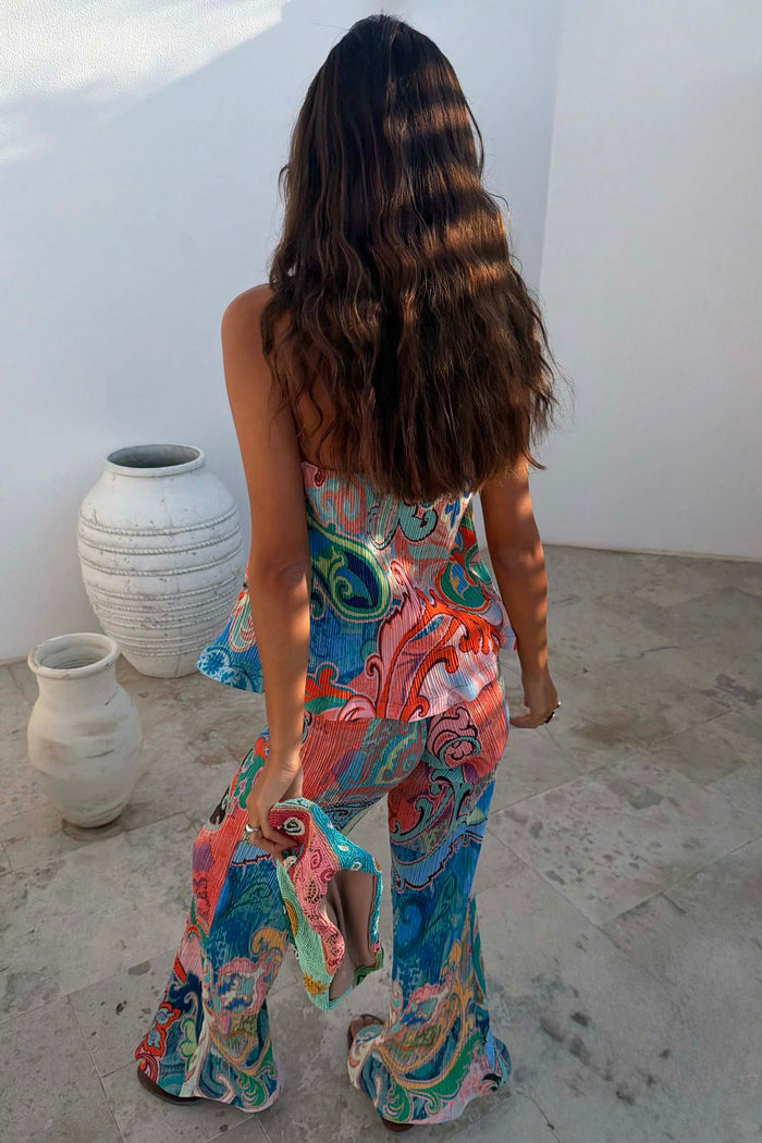 Blue Mari Plisse Trousers in a vibrant paisley Mari print and textured fabric, styled as a summer co-ord.