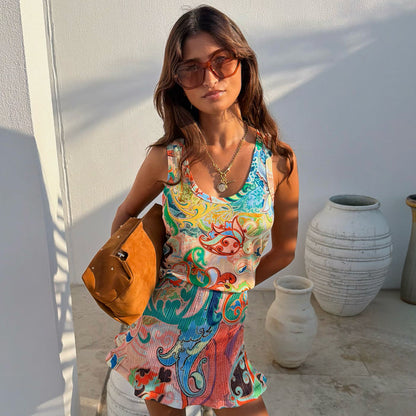 Blue Mari Ribbed Tank in a pastel paisley print, styled as a co-ord with a matching skirt and tan bag.