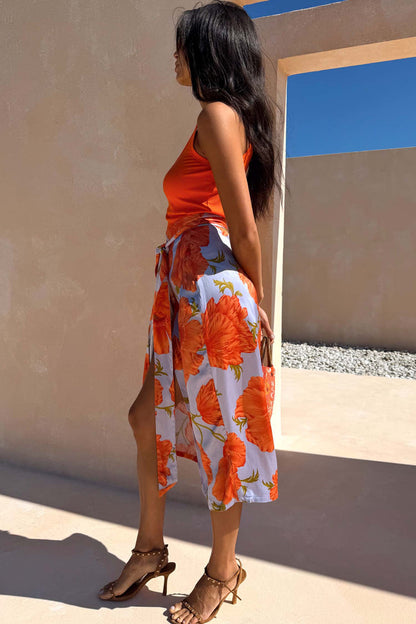 Iconic Blue Poppy Jaspre Skirt featuring an orange poppy print and adjustable multi-wear wrap tie.