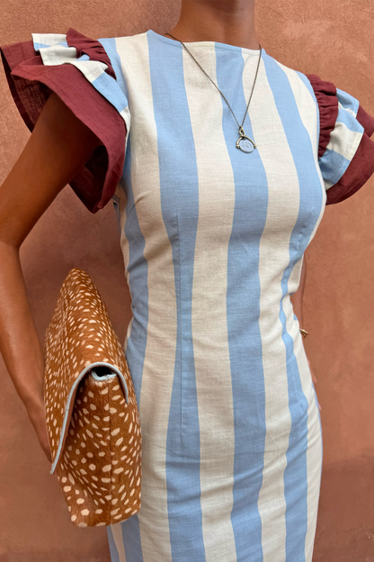 Blue Stripe Alena Midi Dress with vertical stripes and burgundy frill sleeves, styled with a leopard print clutch.
