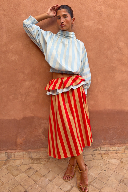 Blue Stripe Batwing Blouse with shirred cuffs and a smocked waist, paired with a red striped ruffled skirt.