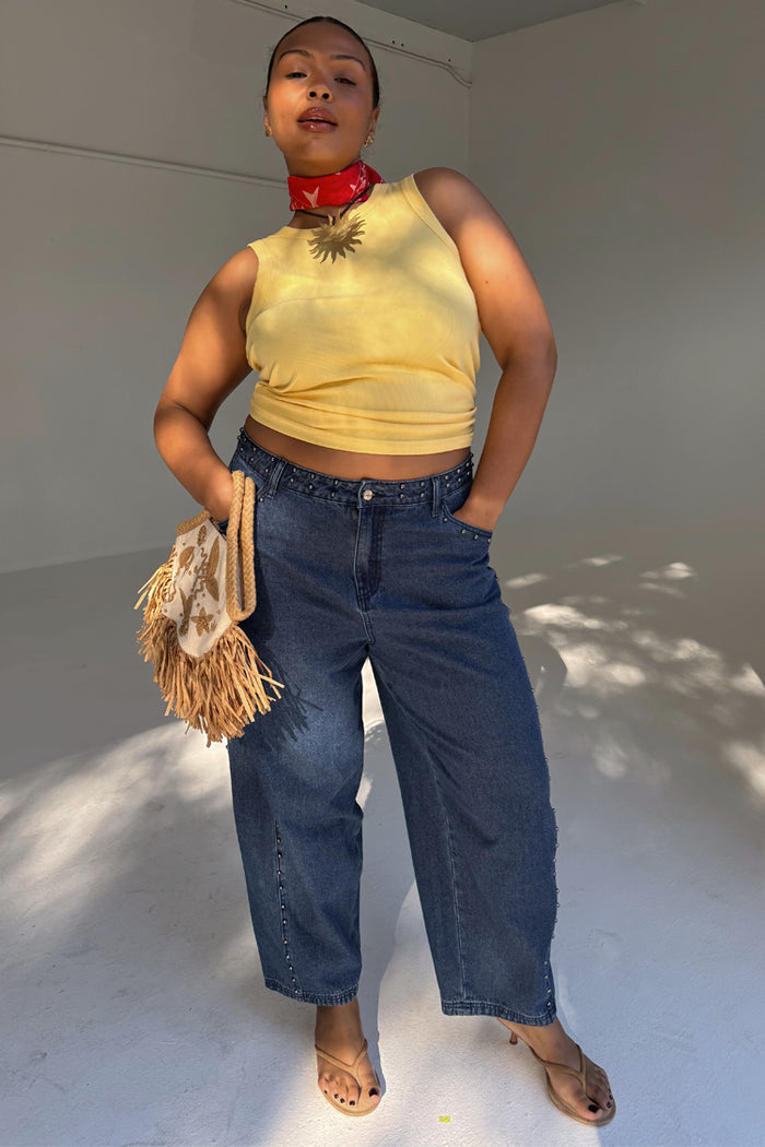 Blue Studded Barrel Jeans with side stud detailing and a barrel silhouette, styled with a yellow top.