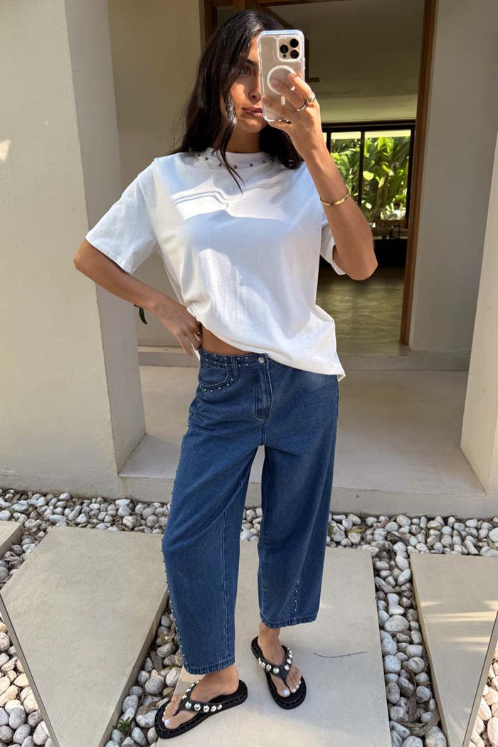 Blue Studded Barrel Jeans with side studs and a structured silhouette, styled with a white t-shirt.