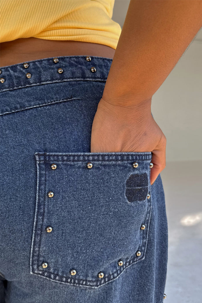 Blue Studded Barrel Jeans detail showing silver studs on the waistband and back pocket with the NFD logo.