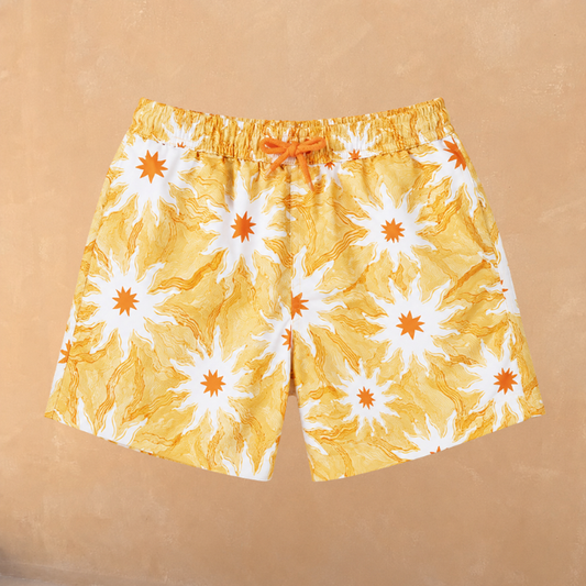 Boy's Yellow Sun Swim Shorts featuring a white and orange sun print and adjustable drawstring in recycled polyester.
