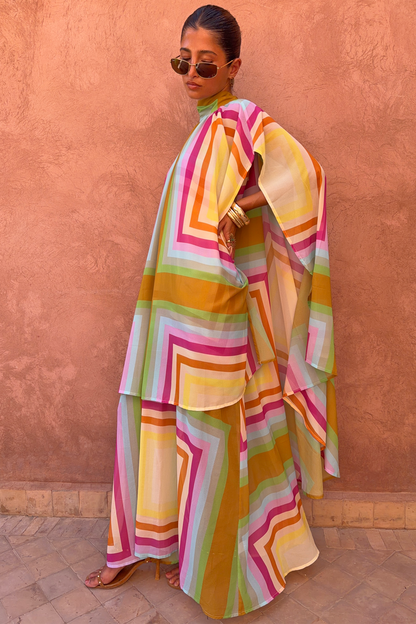 Bright Geo Stevie Maxi Dress with a multi-coloured geometric stripe print and cape sleeves on a model.