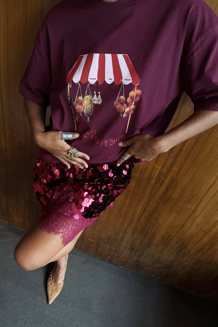 Burgundy Fruit Shop T-Shirt with a Mexico-inspired print, styled with a sequin skirt and lace trim.
