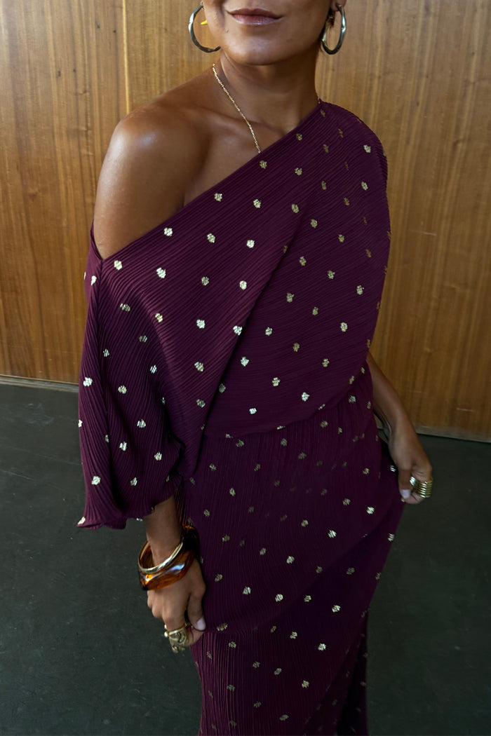 Burgundy Tilly Dress in textured plisse fabric with gold flecks and an off-the-shoulder neckline.