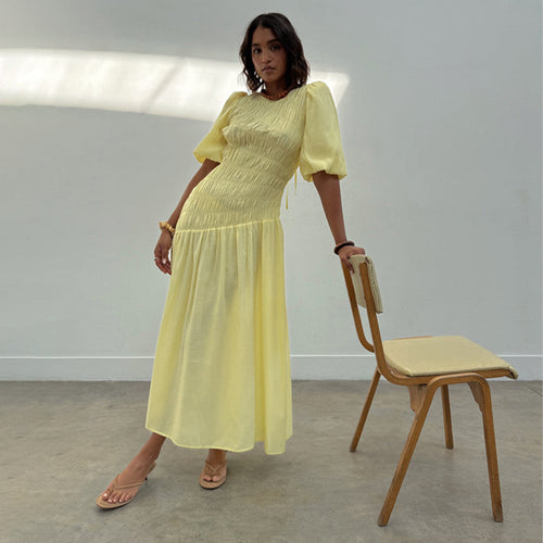 Butter Yellow Shirred Nara Dress with puff sleeves and a pleated midaxi skirt, shown on a model.