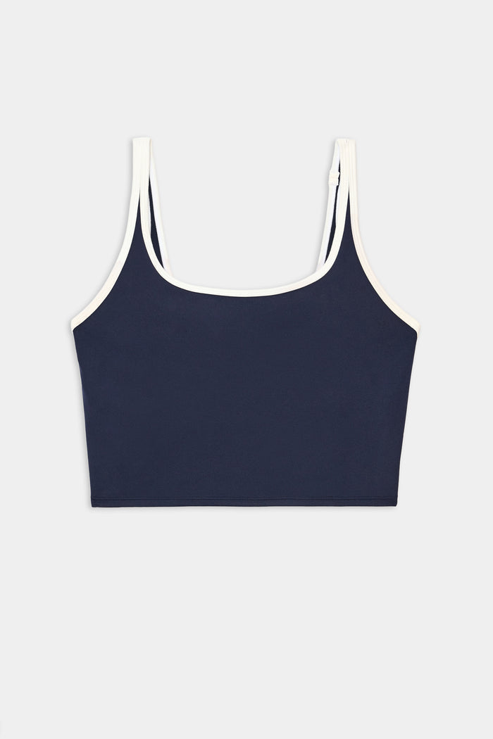 The SPLITS59 Cait Rigor Bralette in Indigo/White features white trim on the straps and neckline and is crafted from soft nylon spandex fabric, shown against a plain white background.