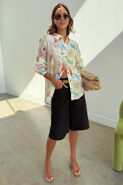 Cream Celestial Marley Shirt in an oversized fit with colourful palm, heart and sun prints, styled with black shorts.