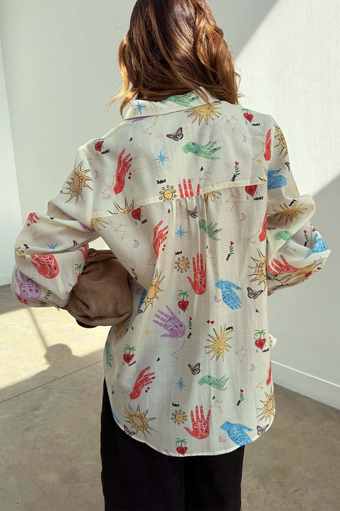 Celestial Marley Shirt in an oversized cream silhouette with colourful sun, heart and hand motifs, seen from the back.
