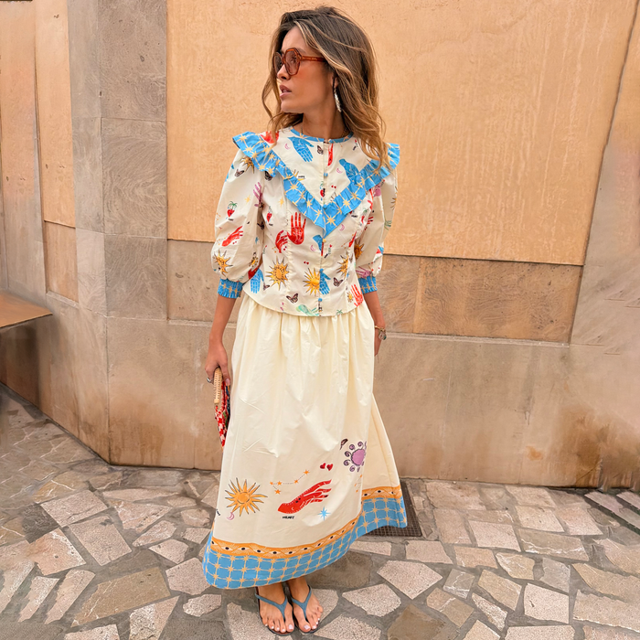 Celestial Nia Top in cream cotton with celestial motifs and blue ruffles, paired with a matching co-ord skirt.
