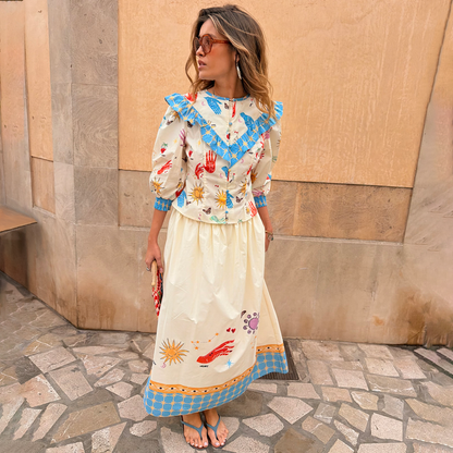 Celestial Nia Top in cream cotton with celestial motifs and blue ruffles, paired with a matching co-ord skirt.