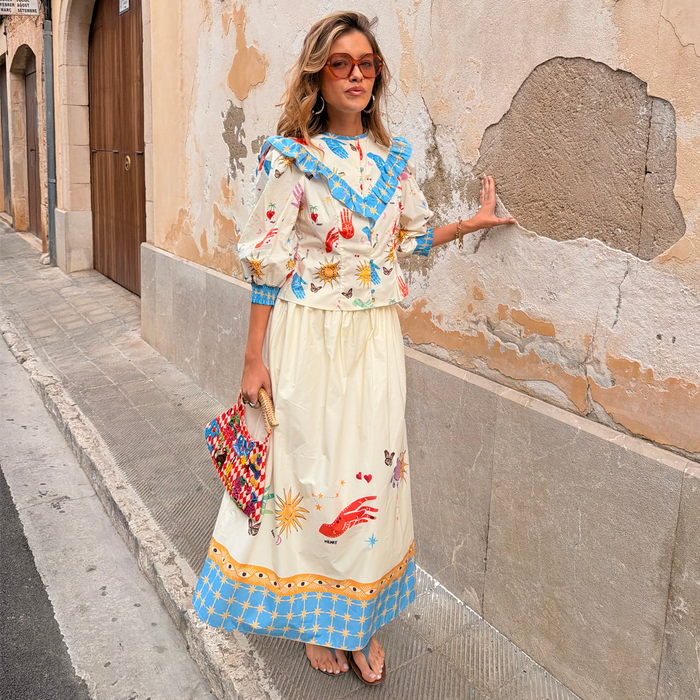 Celestial Nia Top and Talia Skirt co-ord in cream cotton with blue ruffles and sun, palm and constellation motifs.