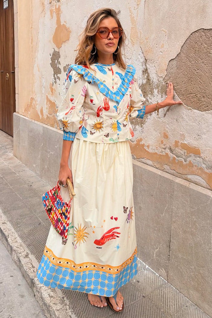 Celestial Talia cotton skirt featuring a sun and palm print with a blue border, paired with the Nia top.