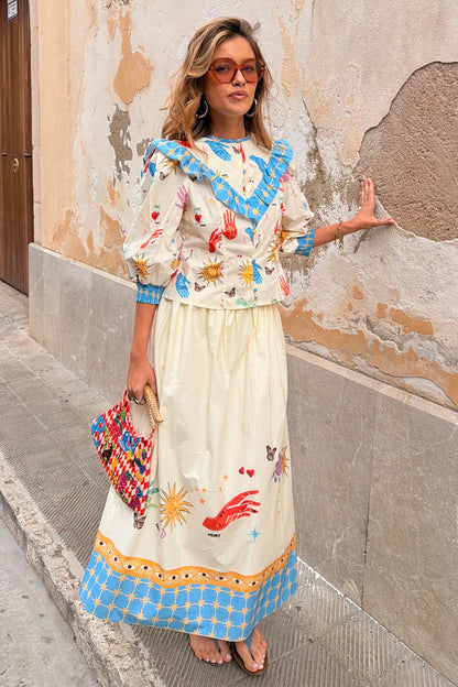 Celestial Talia cotton skirt featuring a sun and palm print with a blue border, paired with the Nia top.
