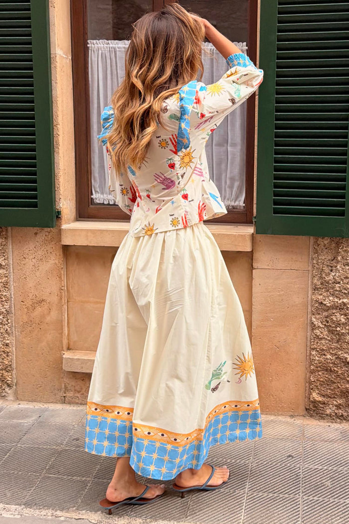 Celestial Talia Skirt in cream cotton with a sun and eye border print, paired with the Nia top.