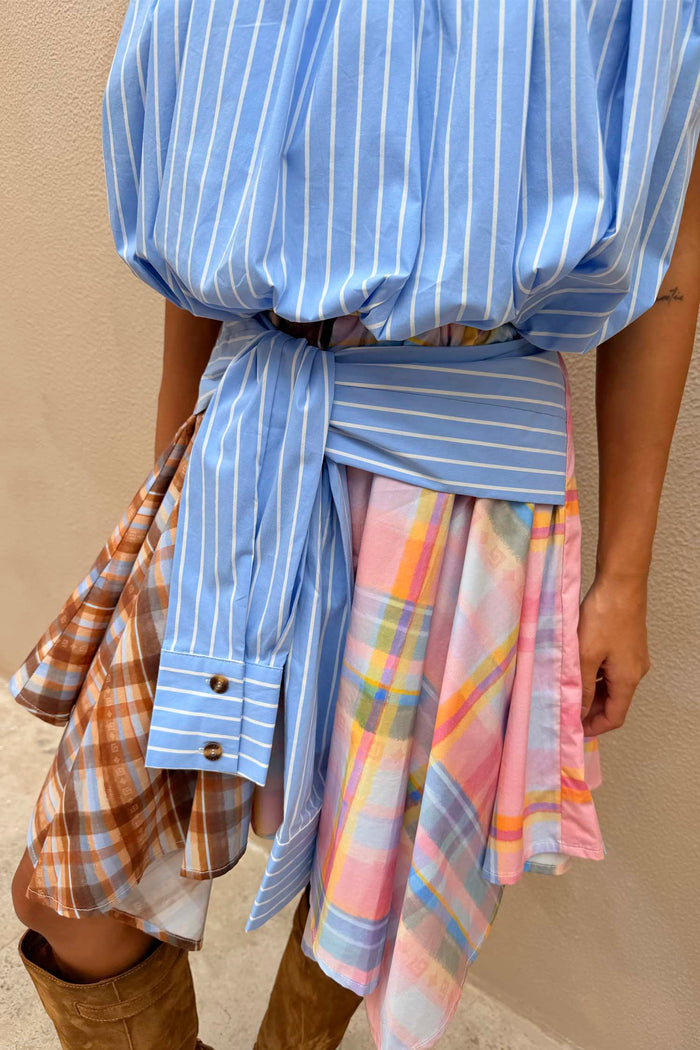 Check Asymmetric Mini Skirt with mixed check prints, a blue stripe tie-waist detail and an asymmetric hanky hem.