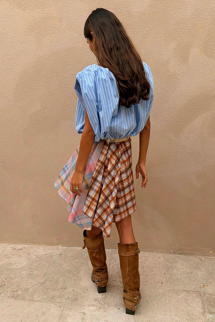 Check Asymmetric Mini Skirt with mixed check print, hanky hem and blue stripe shirt tie detail, styled with brown boots.