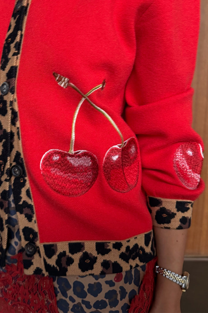 Red Cherry Holly Cardigan detail highlighting the embroidered cherry motifs and leopard print knit trim.