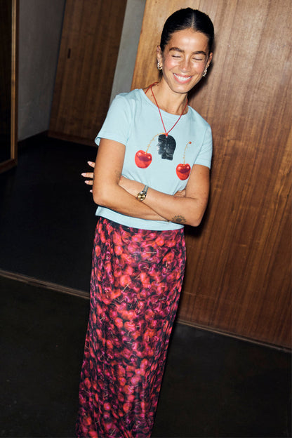 Red Cherry Mesh Dorris Skirt with a vibrant cherry print, styled with a blue graphic tee and designed in London.