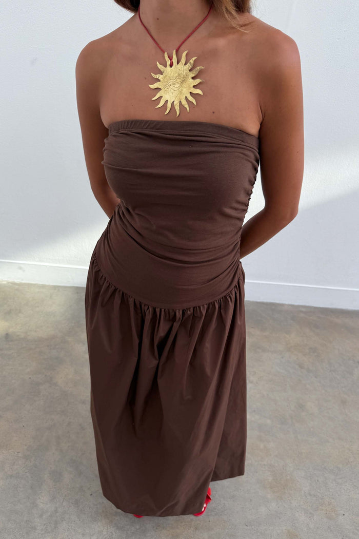 Chocolate Lola Mid-axi Dress featuring a ruched bodice and full skirt, styled strapless with a gold sun pendant.