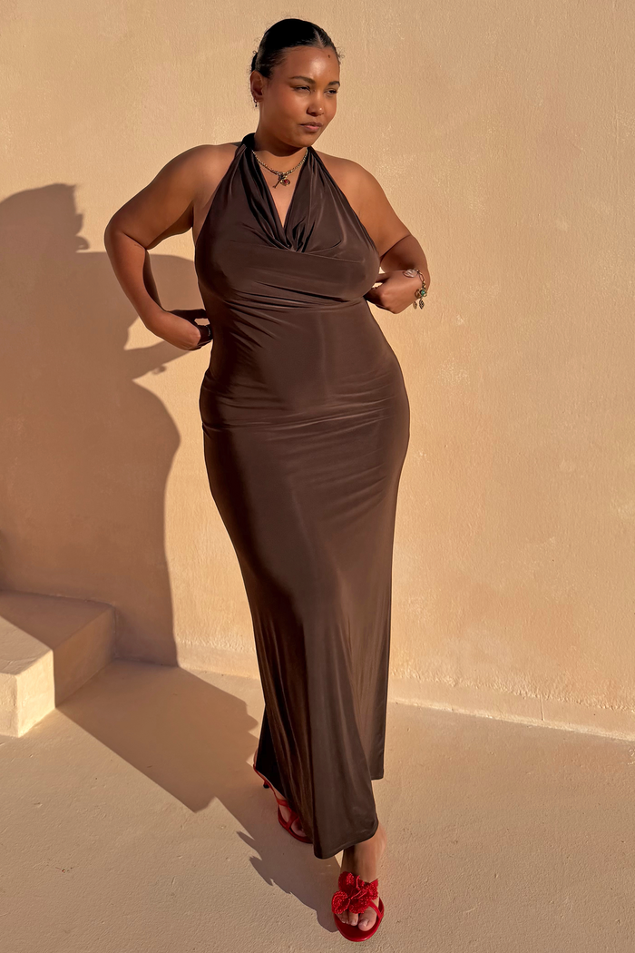 Chocolate Sabine Dress, a brown draped cowl halter maxi in soft stretch fabric, highlighting curve fashion in the sun.