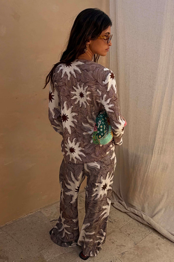 Chocolate Soleil Ellie Trousers and matching top featuring white sun motifs in a wide-leg co-ord.