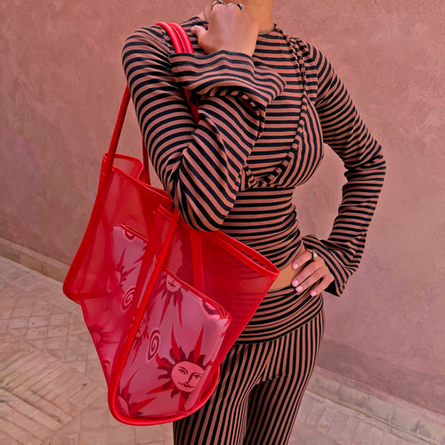 Chocolate Stripe Top with Bra Detail and flared sleeves, styled with co-ord trousers and a red mesh bag.