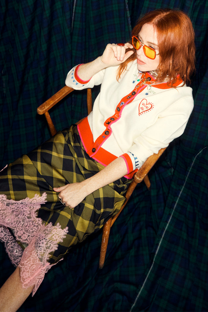 White Choose Love Cardigan with red trims and heart embroidery, worn by Angela Scanlon with a green checked lace skirt.
