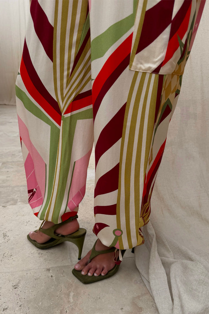 Cirque Cargo Naomi Trousers featuring a bold multicoloured abstract print and balloon leg silhouette.