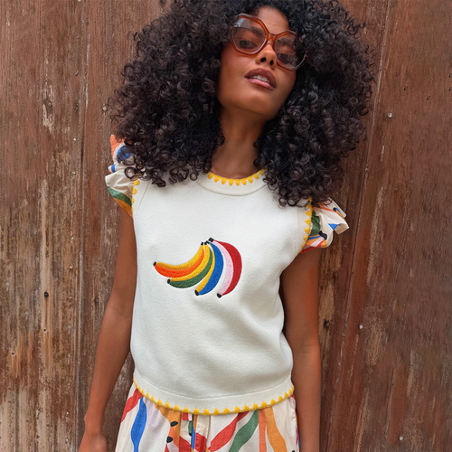 Cream Banana Tank in a knit with a colourful embroidered motif and yellow scalloped edges on a model.