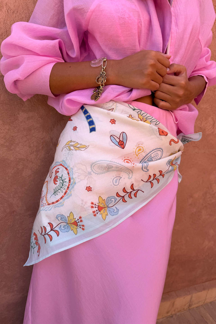 Cream Bandana in Tigress Print styled as a multi-wear waist accessory, featuring colourful paisley and motifs.