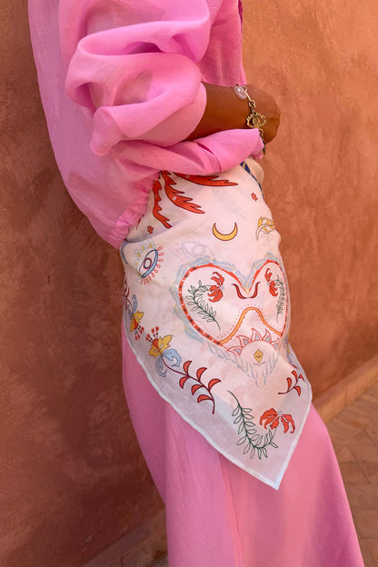 Cream Bandana in Tigress Print with heart and eye motifs, tied around the waist as a multi-wear accessory.